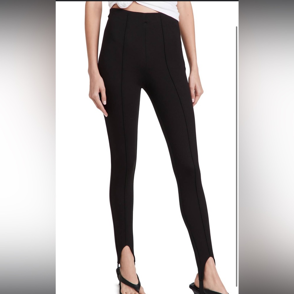 Mid-weight knit
Pintucks at front and back
Stirrup cuffs
High rise